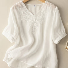 Light beige women's summer blouse with V-neck and flowy linen fabric, casual style perfect for warm weather.