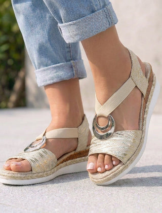 Beige Tammy Bradley peep-toe wedge sandals for women with open toes and tan wedge heels on a neutral background.