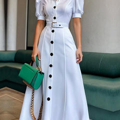 White maxi dress with puff short sleeves, belted waist, button details, and lapel collar, featuring a stylish solid color design.