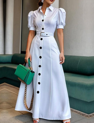 White maxi dress with puff short sleeves, belted waist, button details, and lapel collar, featuring a stylish solid color design.
