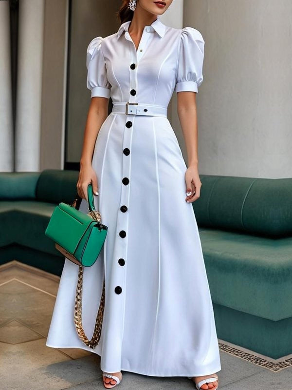 White maxi dress with puff short sleeves, belted waist, button details, and lapel collar, featuring a stylish solid color design.
