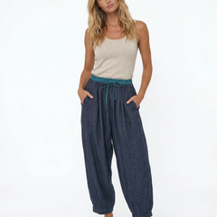 Light-colored tapered linen trousers for women, loose pull-on style, casual and comfortable pants for everyday wear.