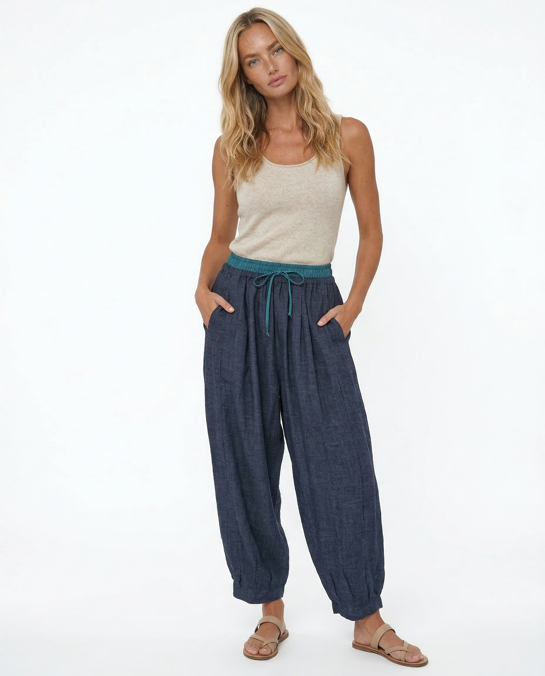Light-colored tapered linen trousers for women, loose pull-on style, casual and comfortable pants for everyday wear.