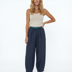 Beige tapered linen trousers for women with a loose, pull-on style, showcasing casual and comfortable pants design.