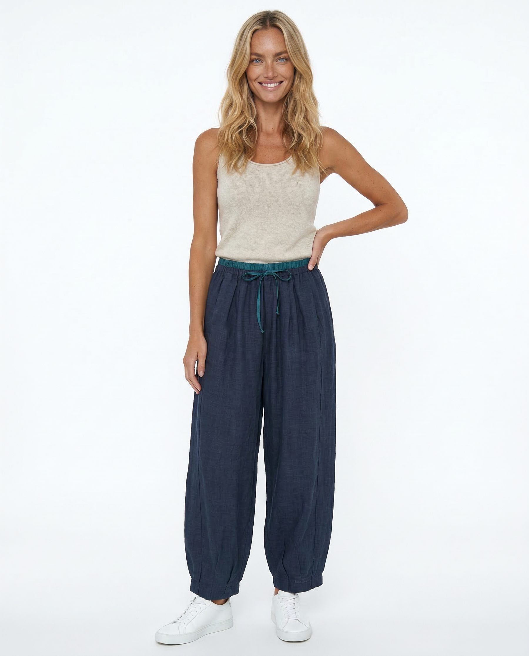Light beige tapered linen trousers for women, loose pull-on style, casual pants with comfortable fit and relaxed silhouette.