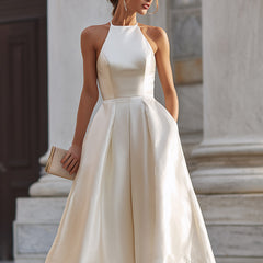 Elegant halter-neck pleated midi dress for women, featuring flowing fabric and stylish design.