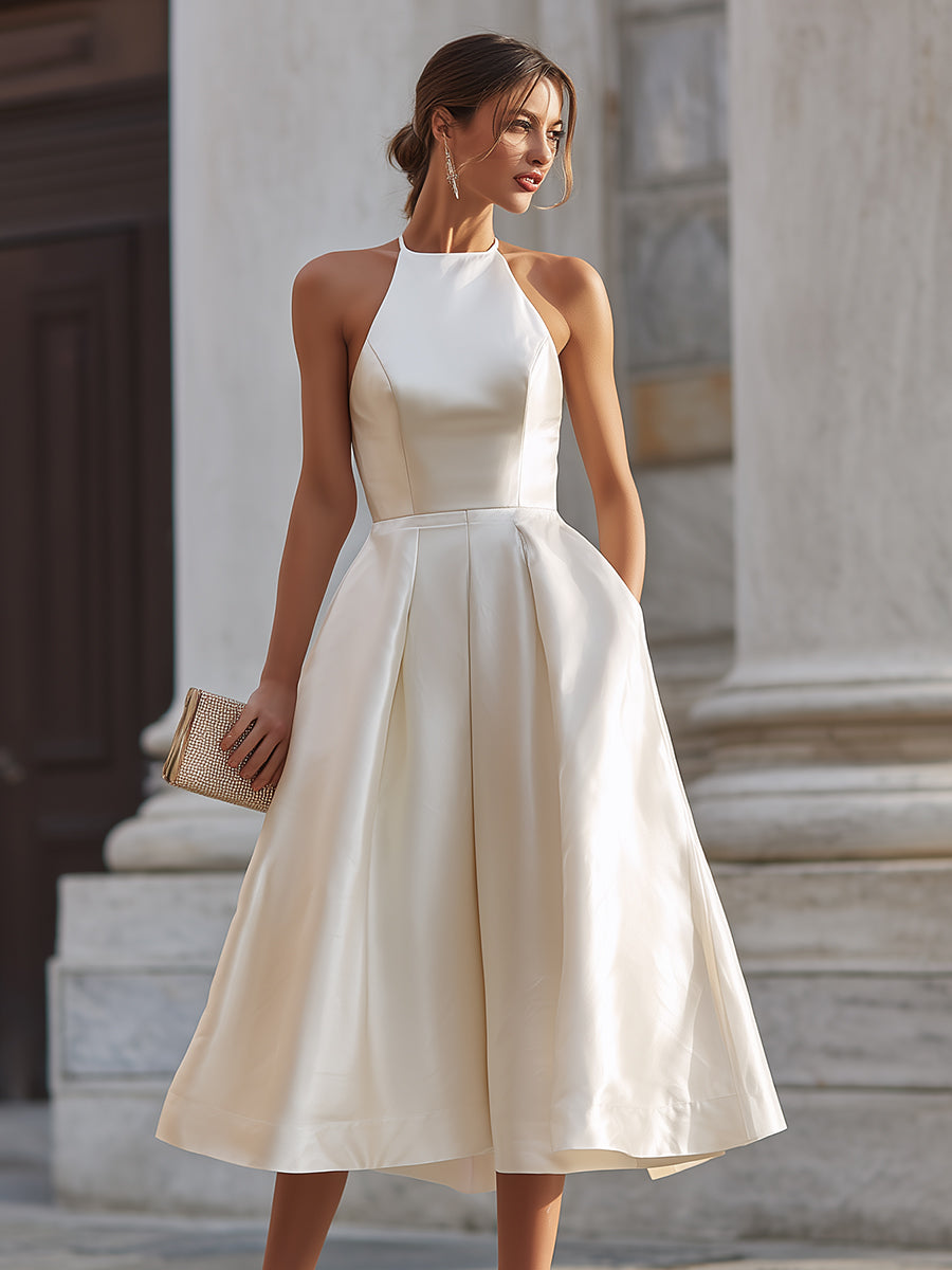Elegant halter-neck pleated midi dress for women, featuring flowing fabric and stylish design.