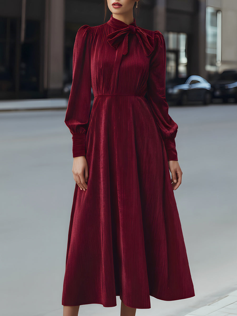 Burgundy velvet pleated bow-neck midi dress by My Store, featuring a stylish cocktail dress design with elegant pleats and a bow neckline.
