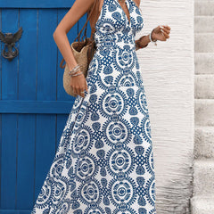 White halter print backless maxi dress featuring a flowing design and elegant style, perfect for summer occasions.
