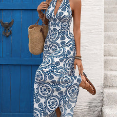 White halter print backless maxi dress with flowing fabric and open back, perfect for elegant summer occasions.