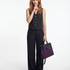 Women's white high-waist wide-leg linen trousers, stylish pants for women, shown on a model with a relaxed fit.