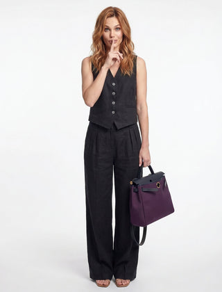 Women's white high-waist wide-leg linen trousers, stylish pants for women, shown on a model with a relaxed fit.