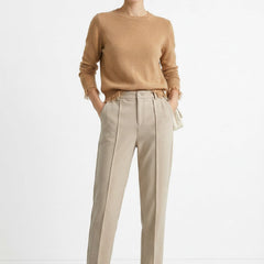 Women's wool tapered trousers by Merino, featuring a tailored fit and classic design, shown on a model in a modern outfit.