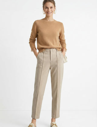Women's wool tapered trousers by Merino, featuring a tailored fit and classic design, shown on a model in a modern outfit.