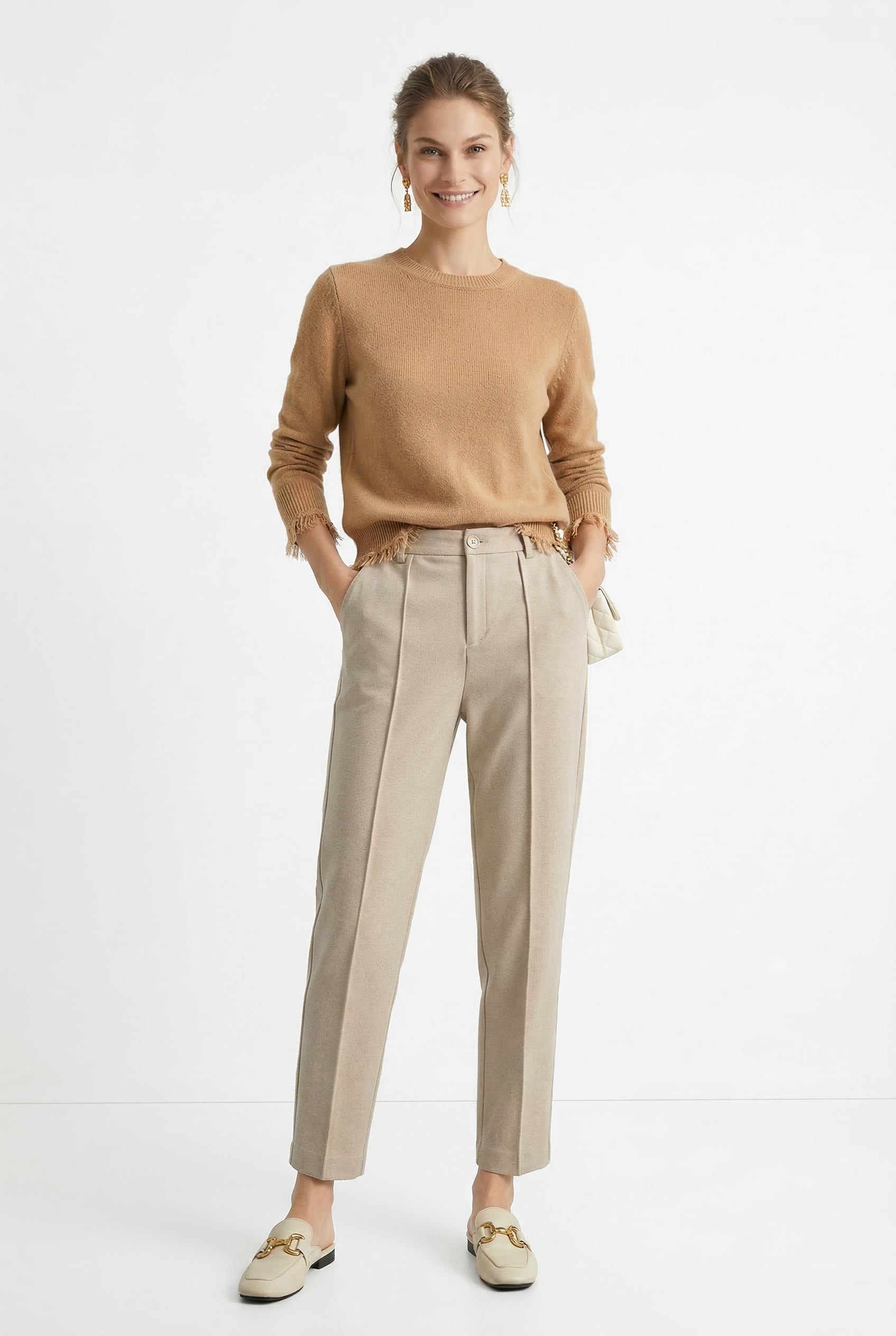 Women's wool tapered trousers by Merino, featuring a tailored fit and classic design, shown on a model in a modern outfit.