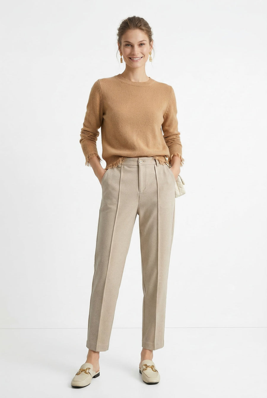 Women's wool tapered trousers by Merino, featuring a tailored fit and classic design, shown on a model in a modern outfit.