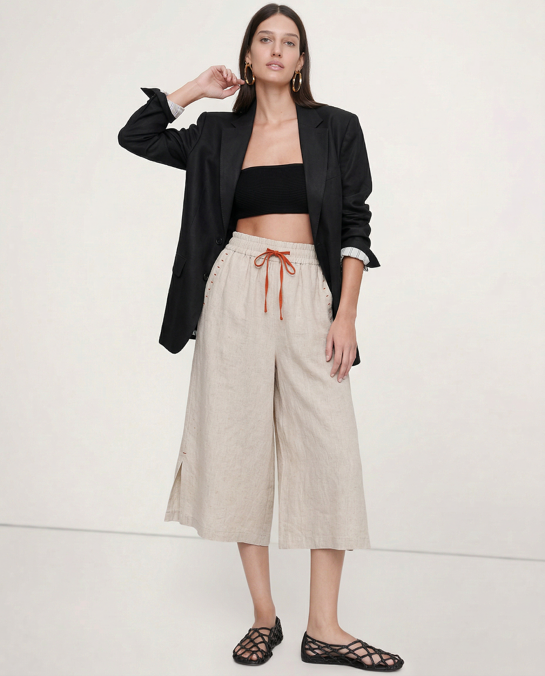 Women's linen wide-leg drawstring trousers featuring a relaxed fit and lightweight fabric, perfect for casual summer wear.