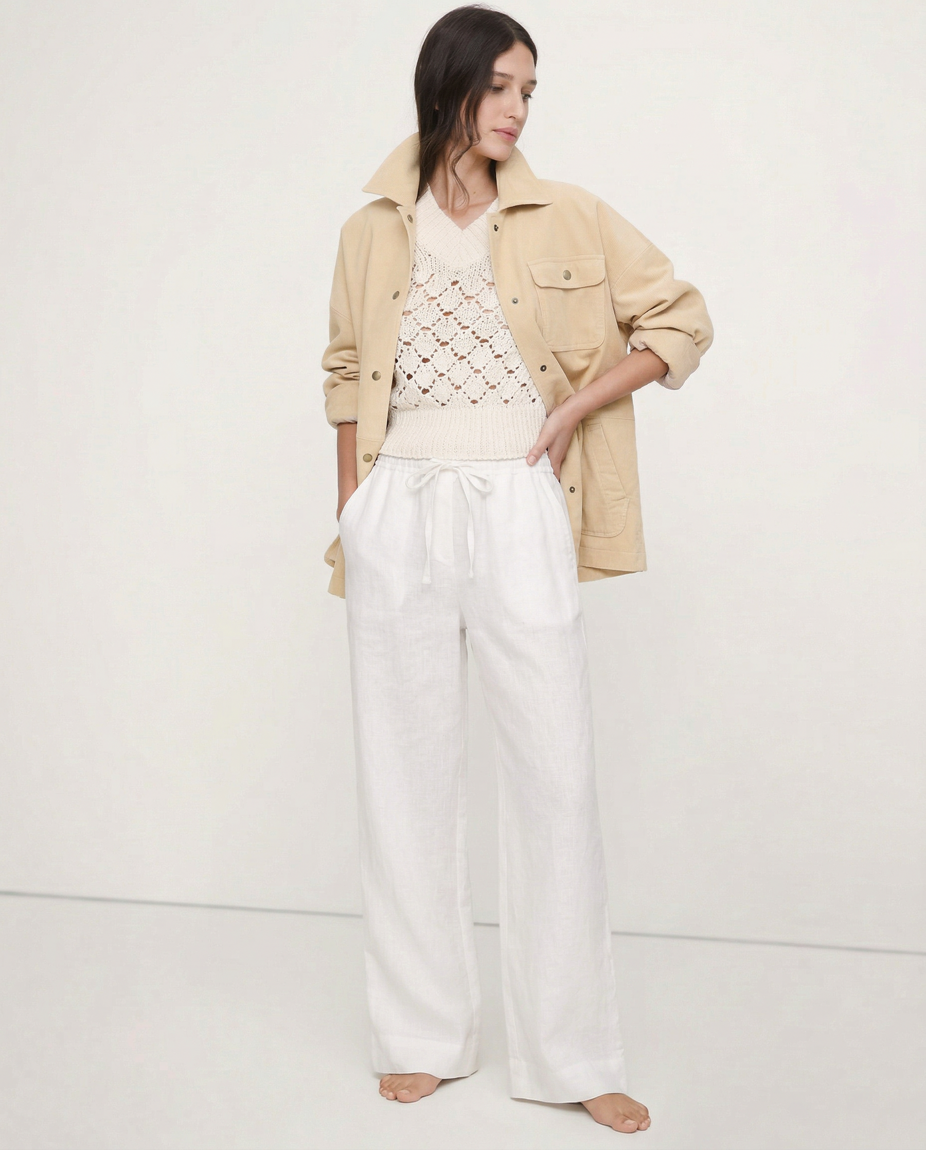 Light beige linen wide-leg trousers for women, featuring loose pull-on design and high-quality fabric, shown on model.