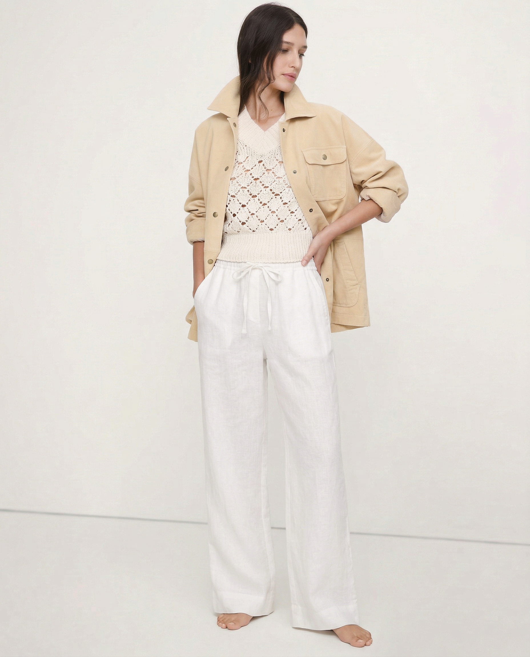Light beige linen wide-leg trousers for women, featuring loose pull-on design and high-quality fabric, shown on model.