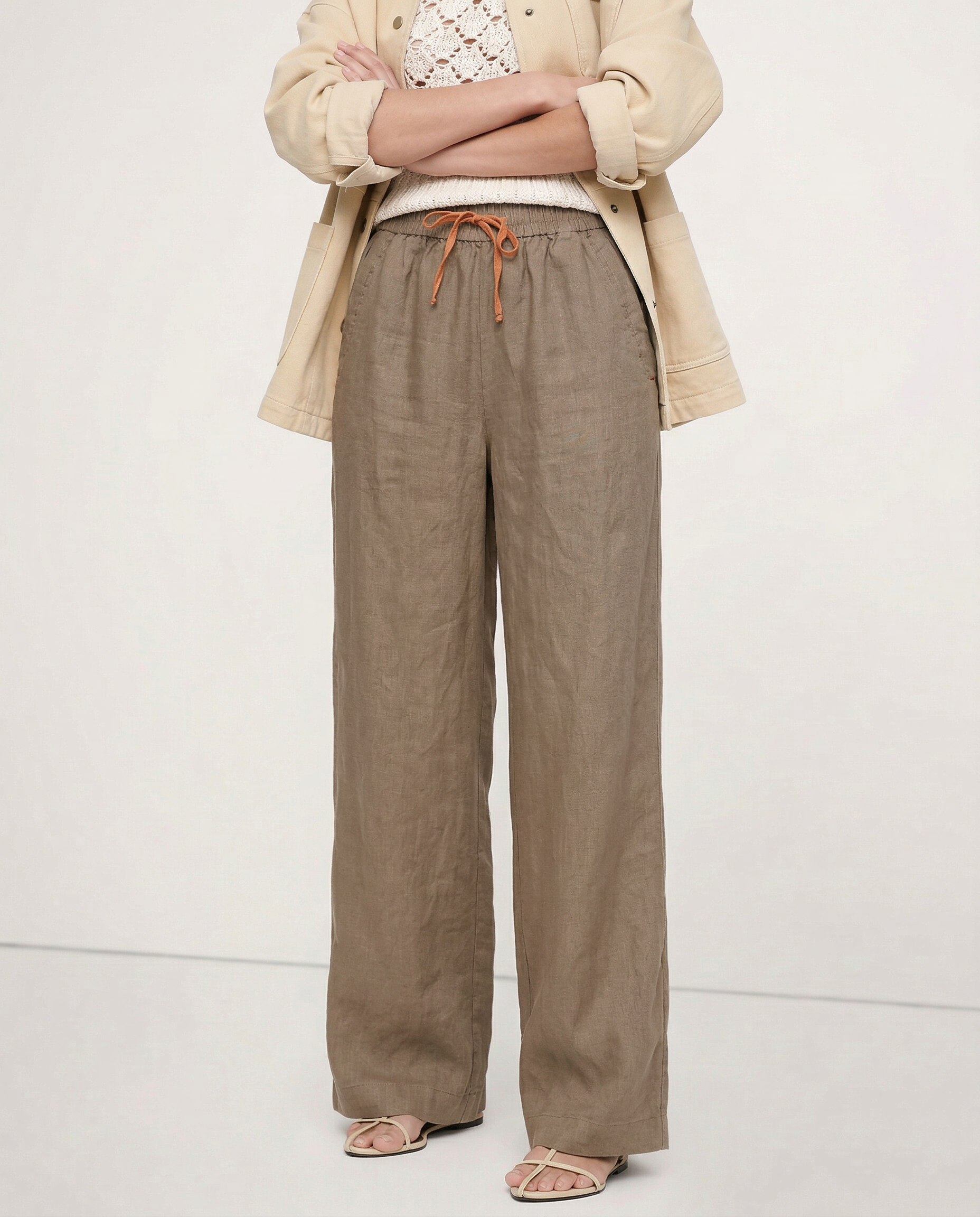Women’s linen wide-leg drawstring trousers featuring a relaxed fit, soft fabric, and loose pull-on style for comfortable wear.