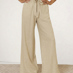 Light beige linen wide-leg trousers for women, loose pull-on pants showing soft fabric and relaxed fit.
