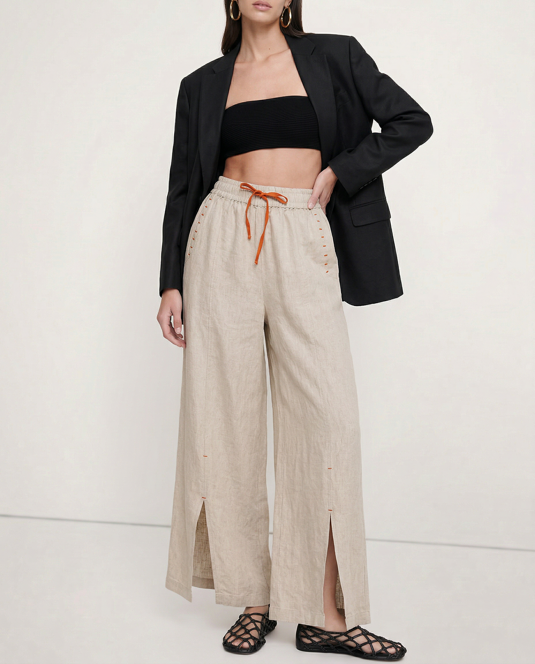 Women’s linen wide-leg drawstring trousers with loose fit, showcasing soft fabric and relaxed style for comfortable, casual wear.