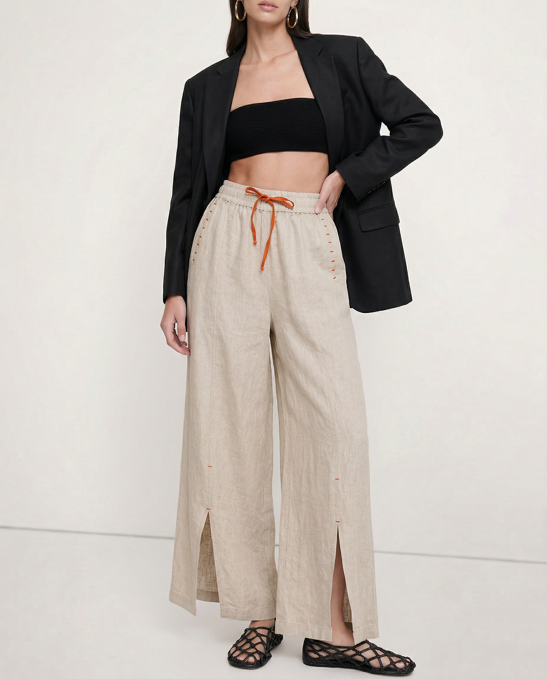 Women’s linen wide-leg drawstring trousers with loose fit, showcasing soft fabric and relaxed style for comfortable, casual wear.