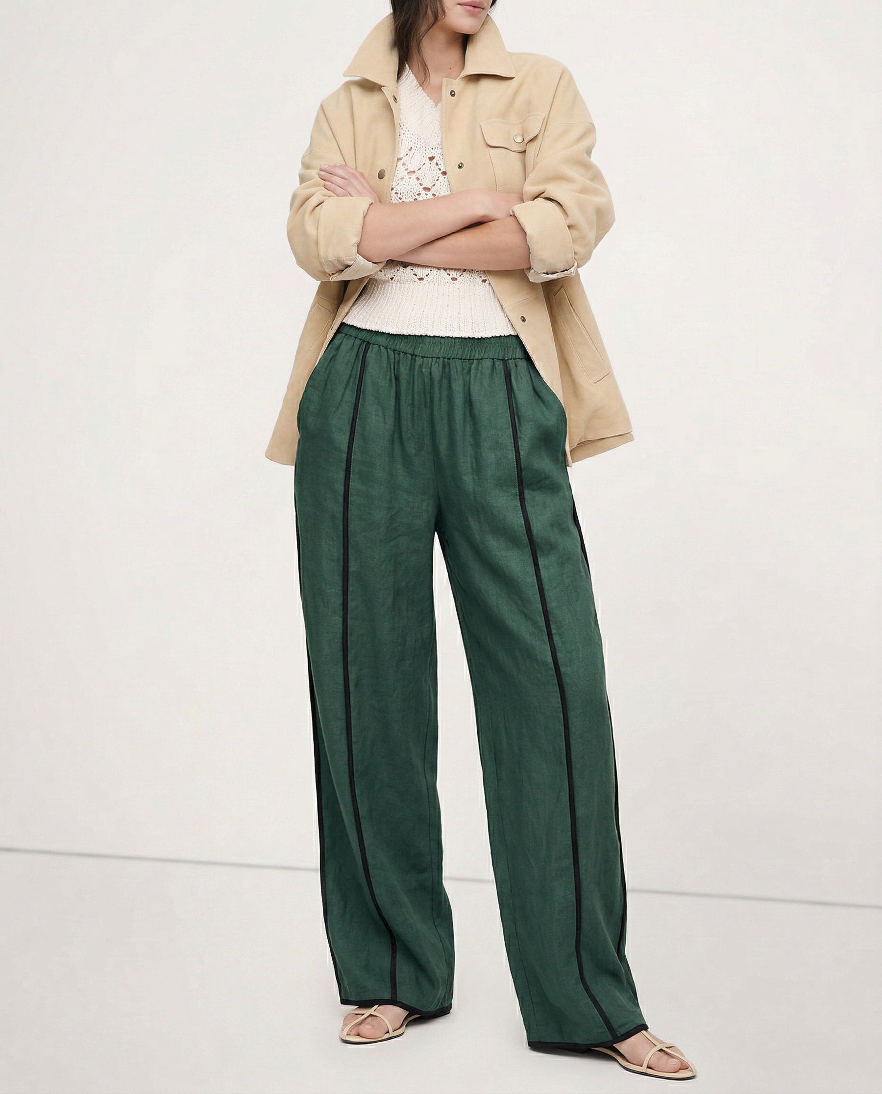 Linen wide-leg elastic-waist trousers for women, showing soft, high-quality linen fabric and relaxed fit in a realistic style.