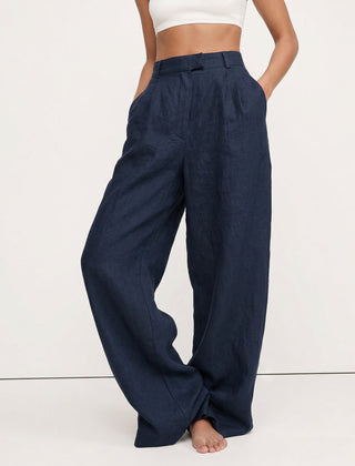 Women's high-waist wide-leg linen blend trousers with a loose pull-on design, showcasing the fabric quality and relaxed fit.