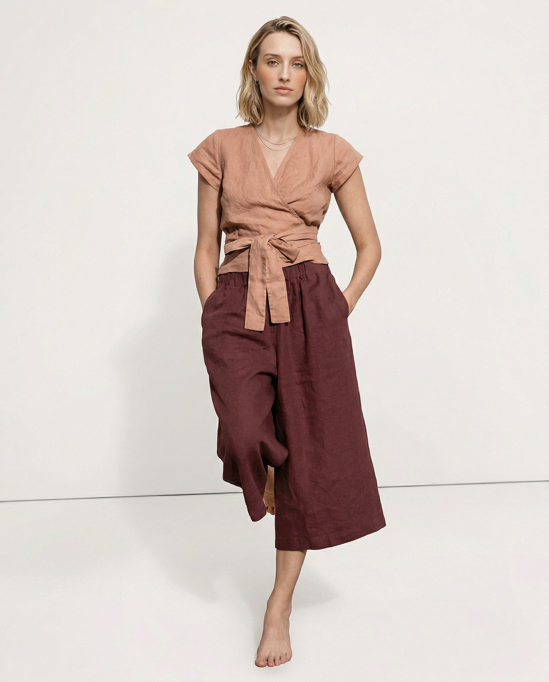 Linen cropped wide-leg drawstring trousers for women, showing high-quality, realistic linen fabric with a relaxed fit.