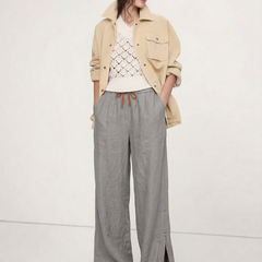 Women's linen wide-leg drawstring trousers with loose fit and soft fabric, shown in natural light highlighting fabric quality.