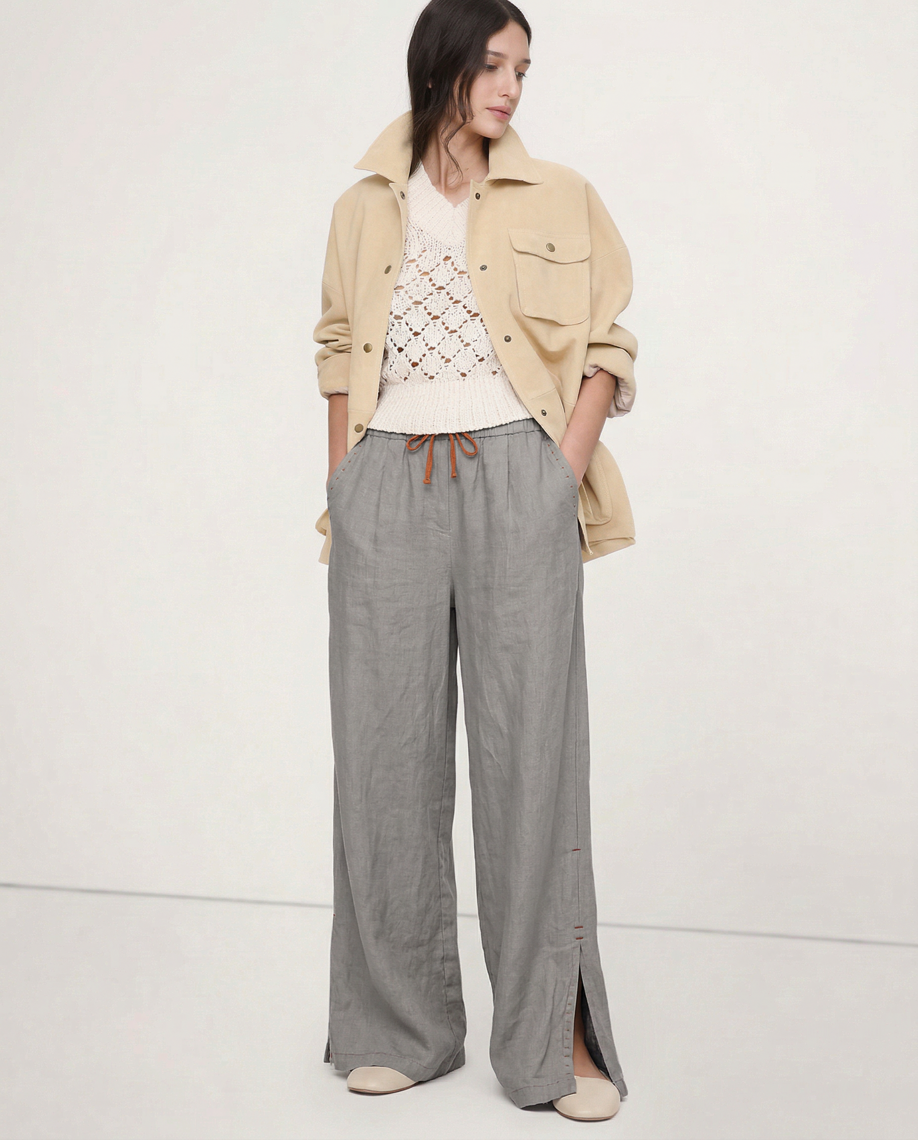 Women's linen wide-leg drawstring trousers with loose fit and soft fabric, shown in natural light highlighting fabric quality.