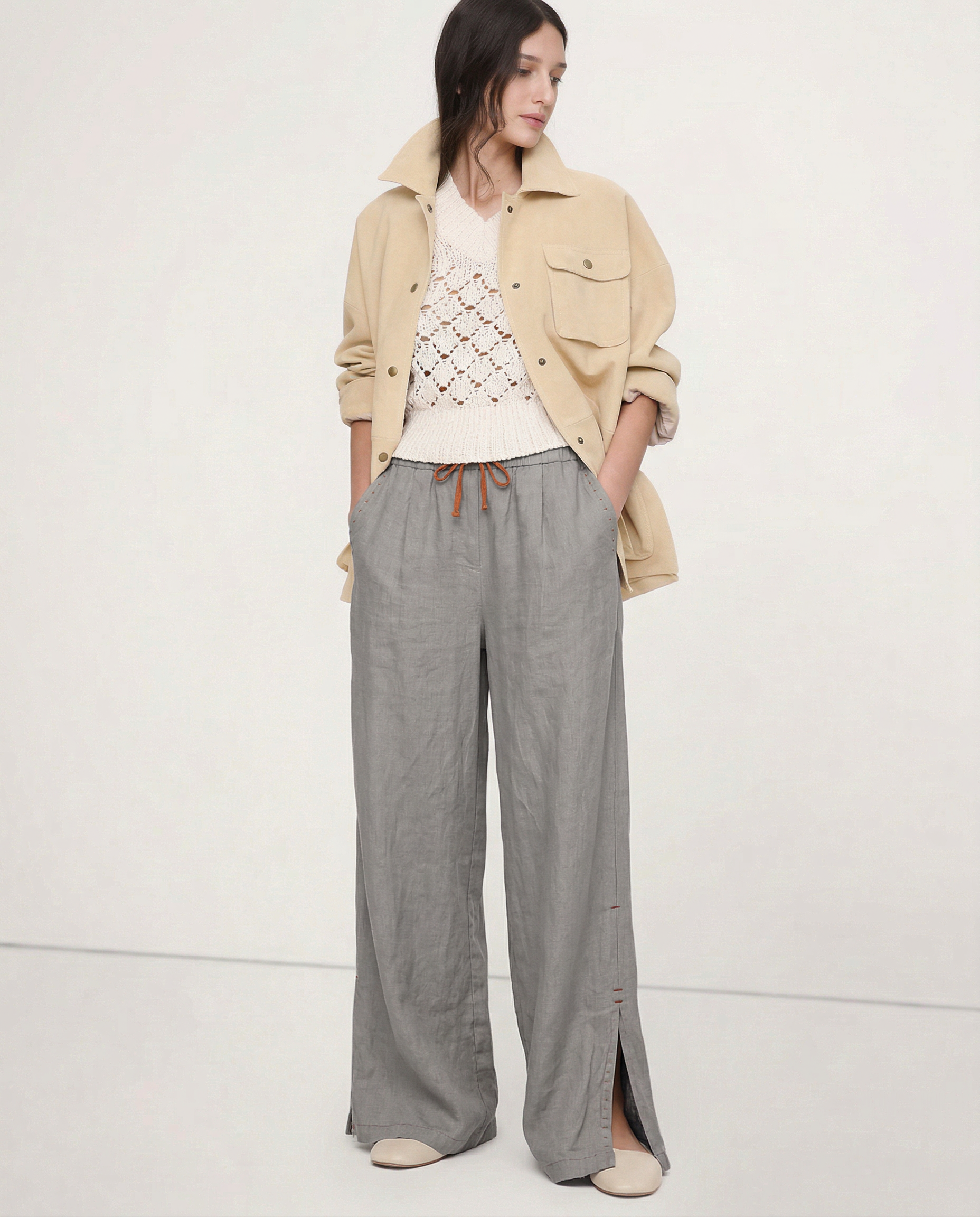 Women's linen wide-leg drawstring trousers with loose fit and soft fabric, shown in natural light highlighting fabric quality.