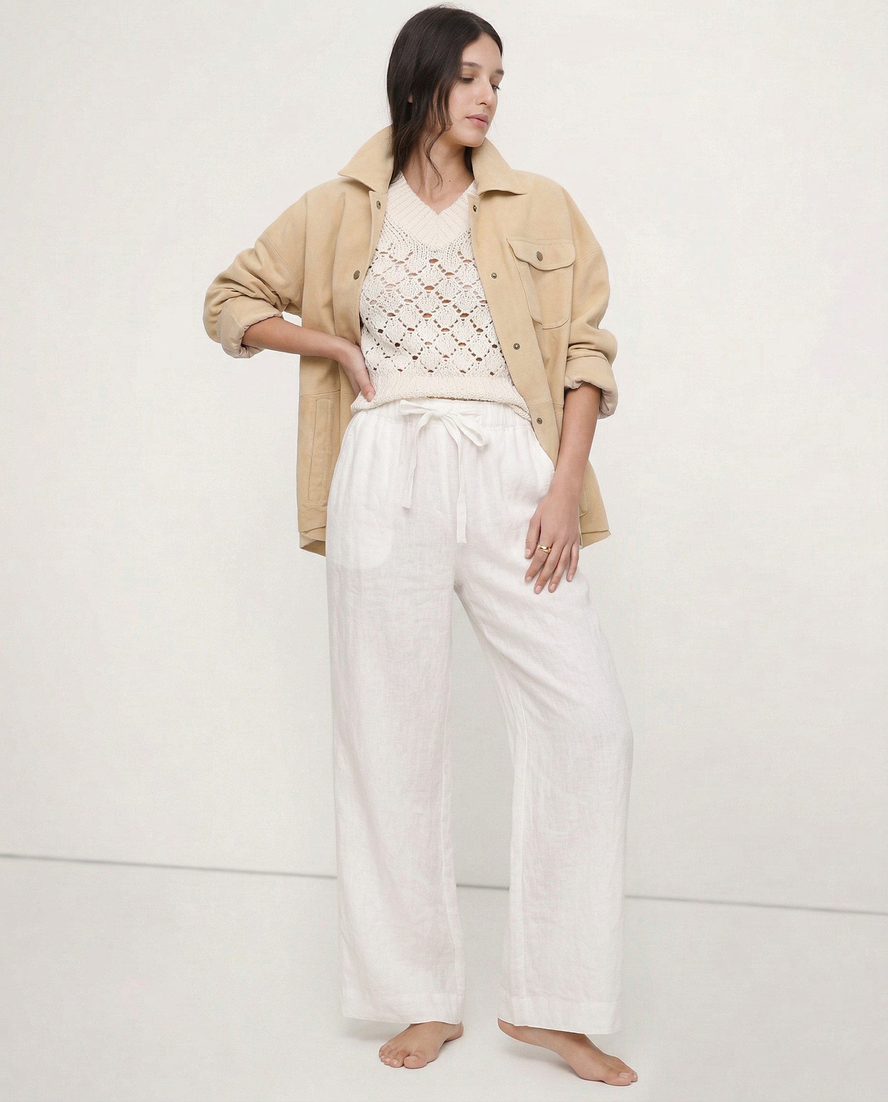 Light beige linen wide-leg women's trousers with a loose, pull-on style and visible high-quality fabric.