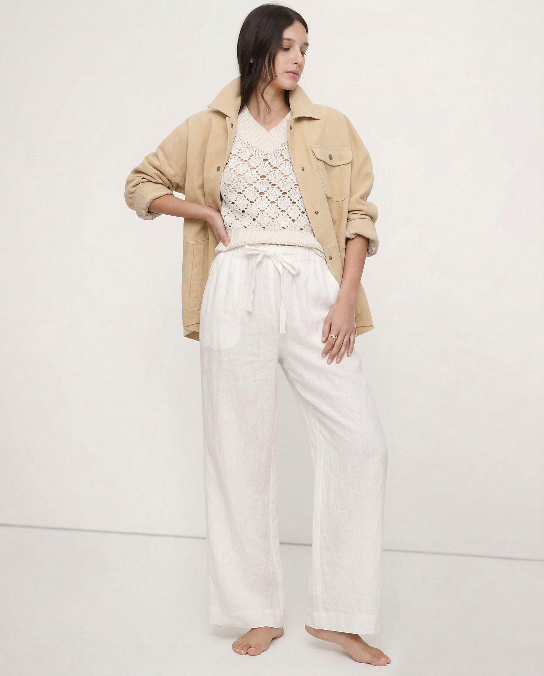Light beige linen wide-leg women's trousers with a loose, pull-on style and visible high-quality fabric.