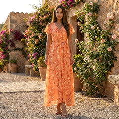 Floral chiffon midi dress with short sleeves and a flowy skirt, featuring a vibrant floral pattern and elegant design.