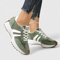 Cushioned orthopedic sneakers for women, stylish and supportive, with a white and gray design and textured sole.