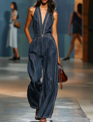 Dark blue denim sleeveless V-neck wide-leg jumpsuit for women, featuring stylish wide-leg pants and a fitted V-neck top.