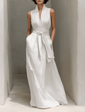Full-body image of a woman wearing a Tammy Bradley linen V-neck maxi dress, featuring a flowing fit and chic style.