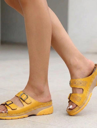 Yellow Tammy Bradley buckle platform slide sandals for women, featuring wide straps and a chunky sole.