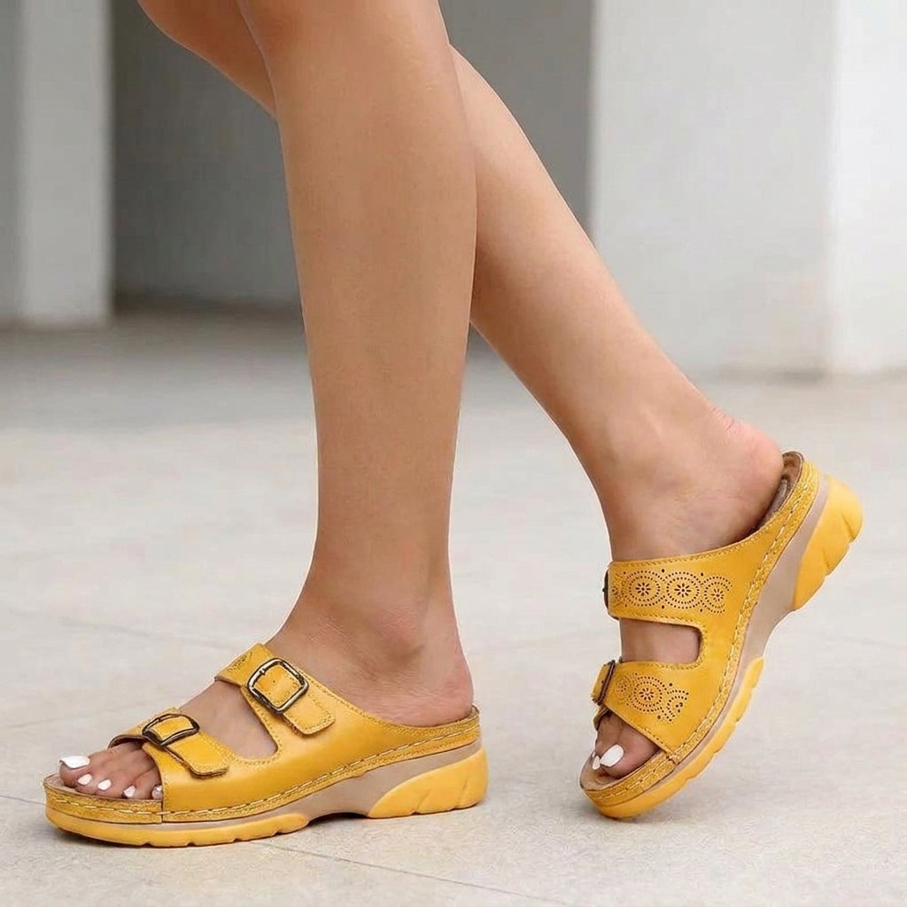 Yellow Tammy Bradley buckle platform slide sandals for women, featuring wide straps and a chunky sole.